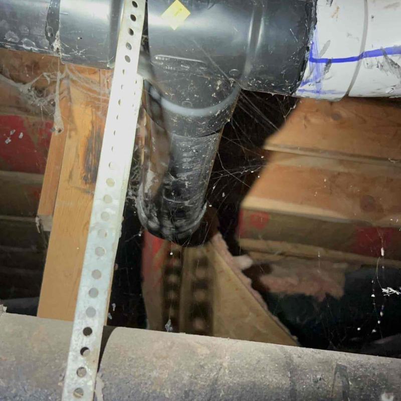 Crawl space black drain pipe with vent fitting