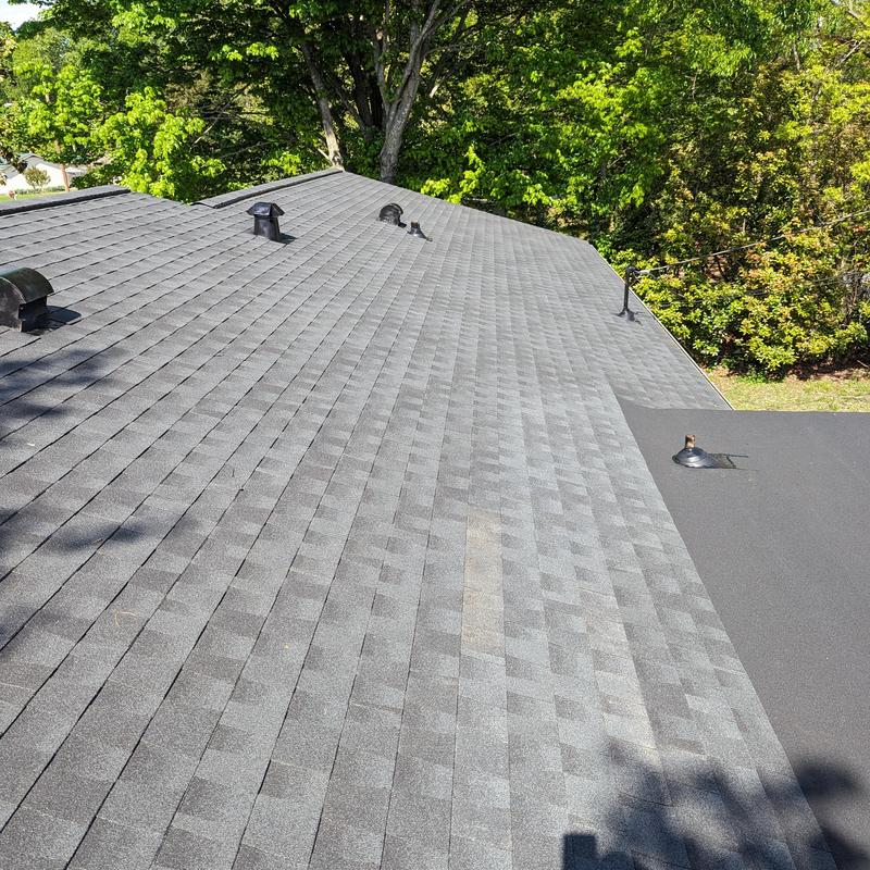 Charcoal asphalt shingle roof with vents and flashing