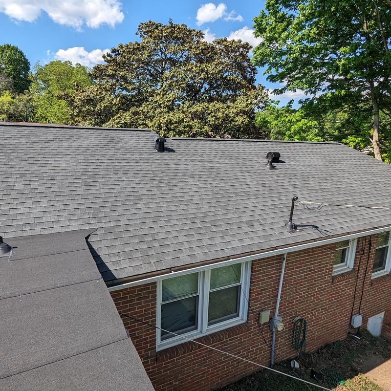 Charcoal asphalt shingle roof with vents and pipe