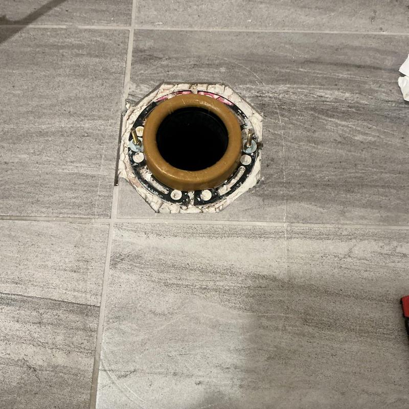 Wax ring and toilet flange on tiled floor