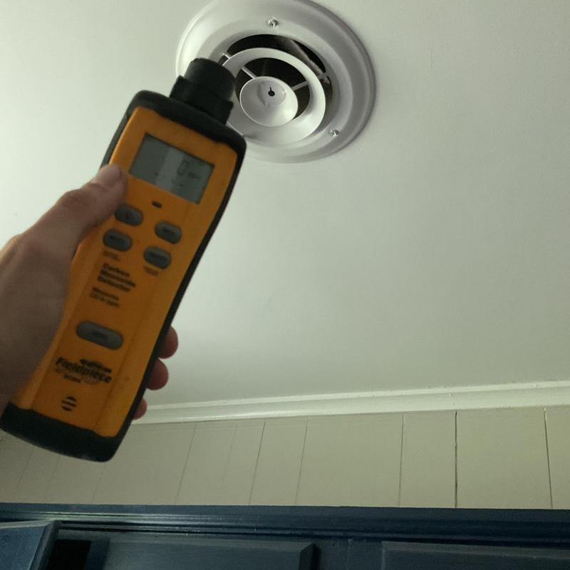 Carbon monoxide monitor testing near ceiling vent