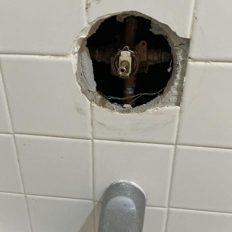 Shower valve cartridge housing in tiled wall cavity