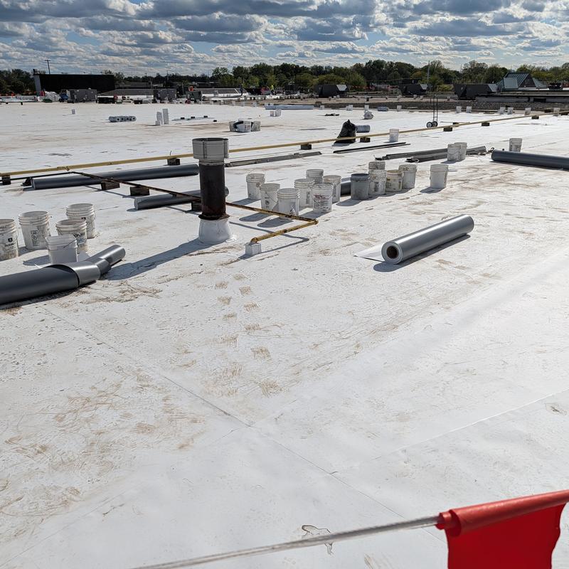 TPO single-ply roof with restoration materials and tools