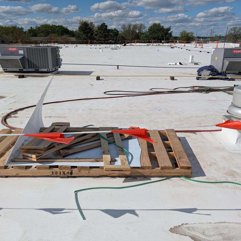 TPO single-ply flat commercial roof restoration with pallets