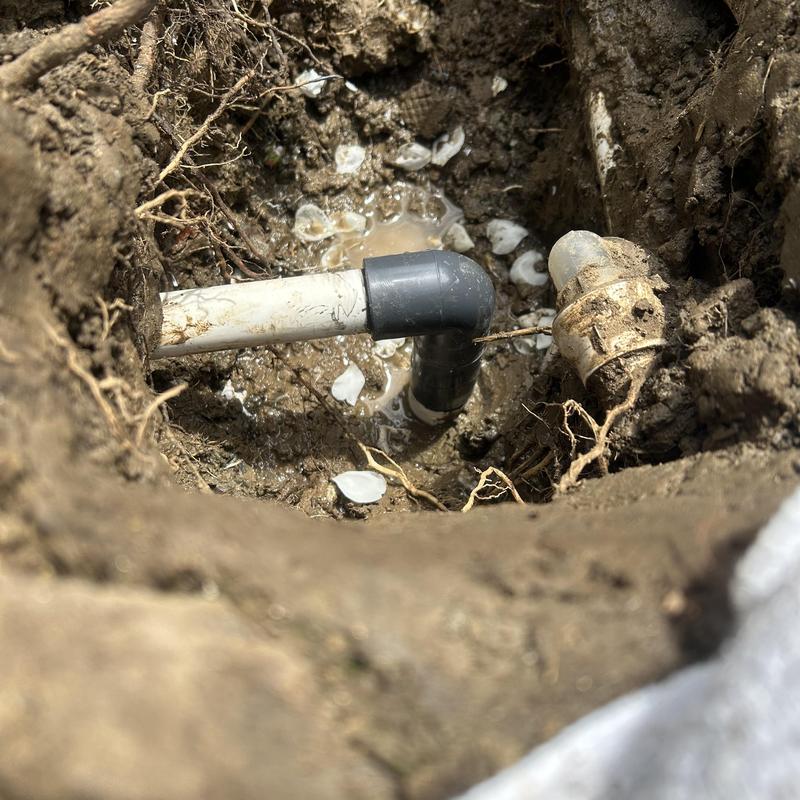 1-inch PVC pipe with elbow fitting installed underground