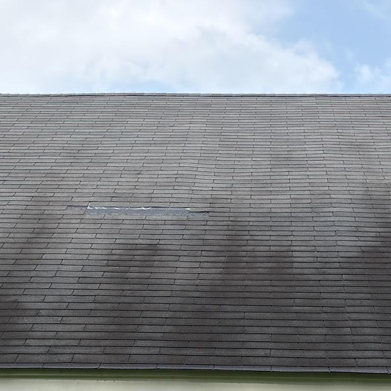 Asphalt shingle roof with patch and discoloration