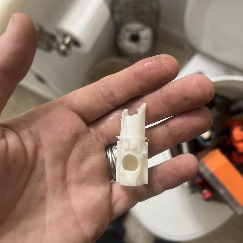 Broken shower diverter stem in hand close-up