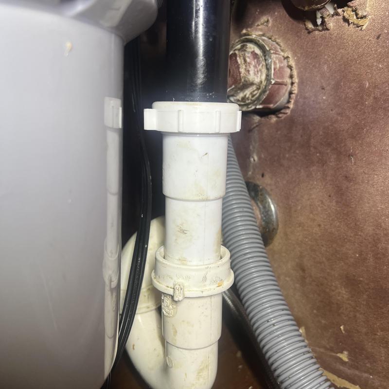 Kitchen sink drain pipe and fittings under cabinet