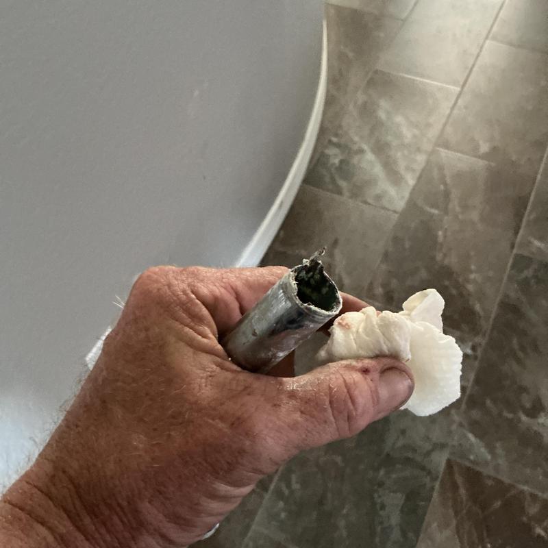 Shower arm with corrosion held during replacement Shower arm with corrosion held during replacement