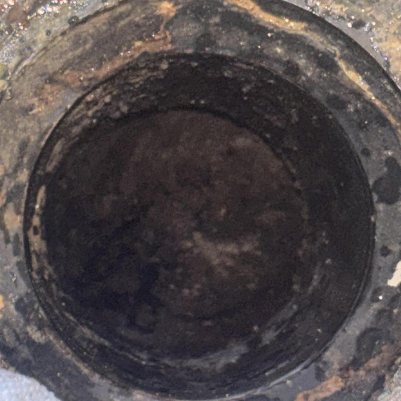 Toilet mainline clogged with debris inside pipe