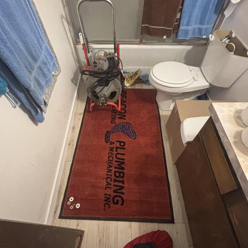 Toilet mainline blockage with sewer machine in bathroom