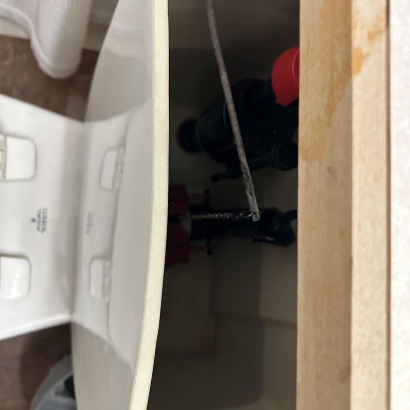 Toilet tank internal flush valve replacement in progress