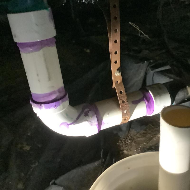 ABS kitchen drain line with fresh purple primer in crawl space