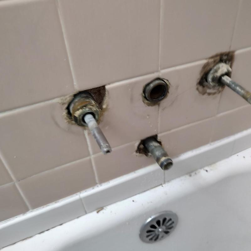 Three-handle tub shower faucet valve stems removed