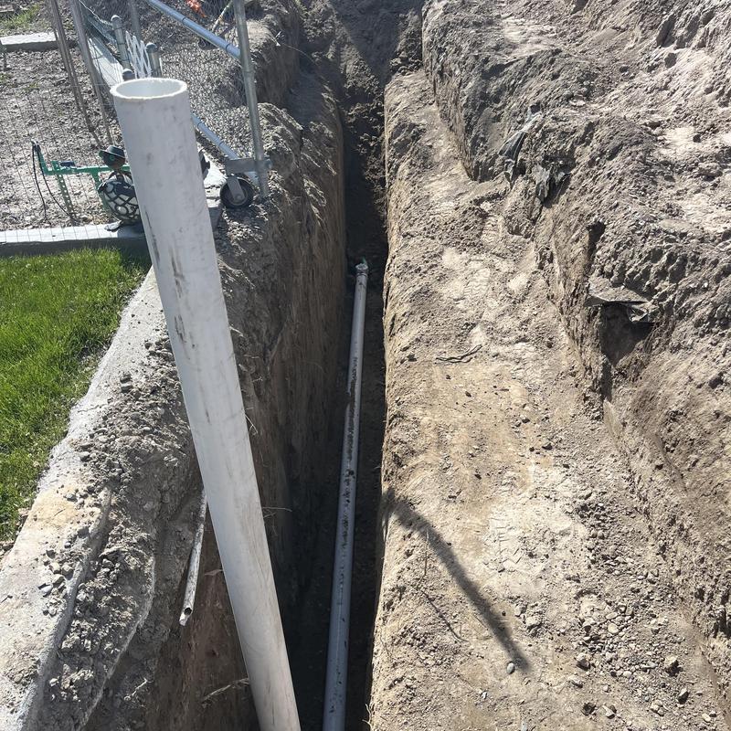 Sewer pipe trench with new PVC pipe installation