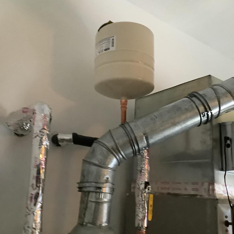 Expansion tank installed above metal HVAC ductwork
