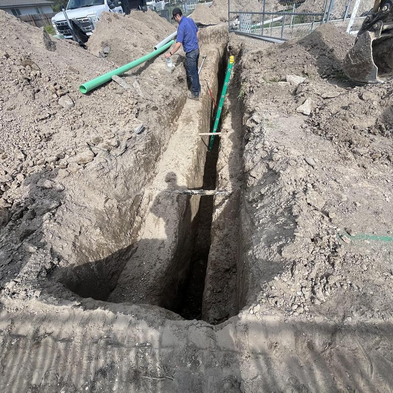 Sewer tap installation on main city sewer line trench