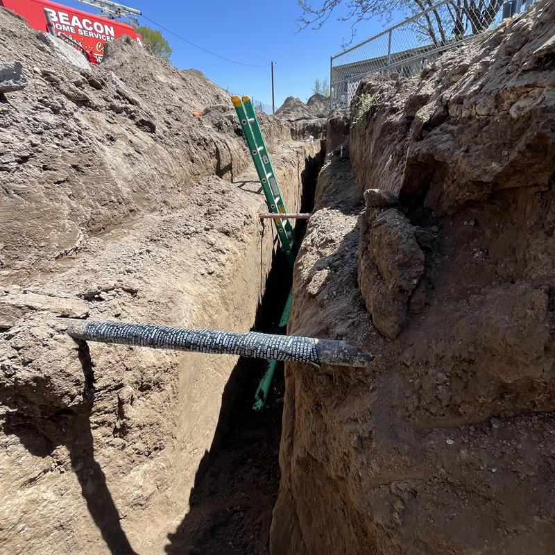 Sewer main line with new sewer tap installation trench