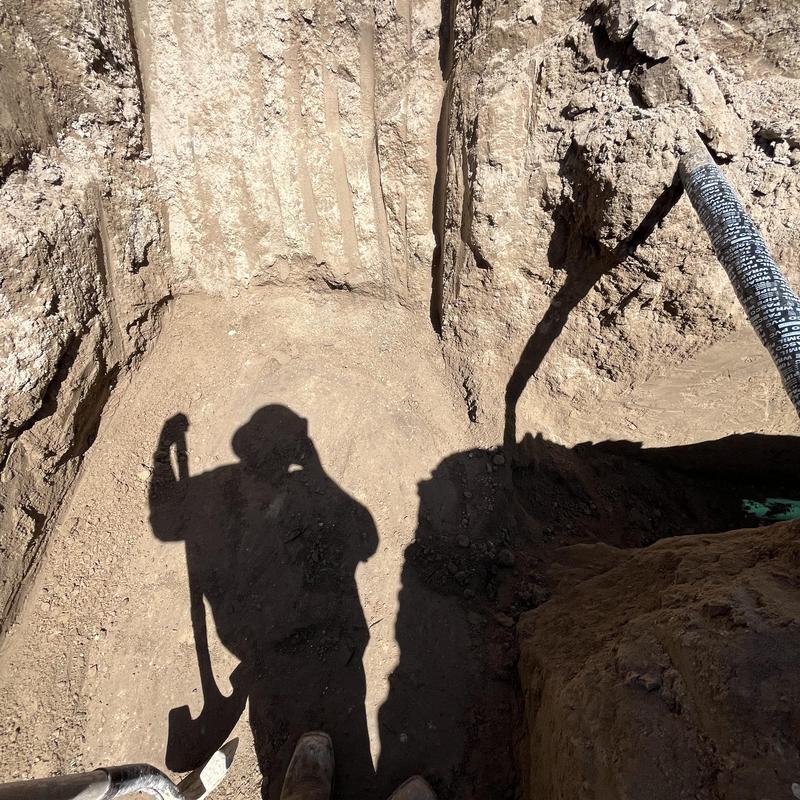Sewer tap installation on main city sewer line trench