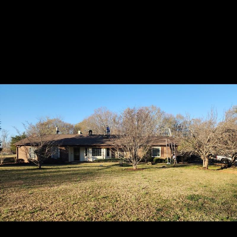 Asphalt shingle roof with workers in Spartanburg SC Asphalt shingle roof with workers in Spartanburg SC