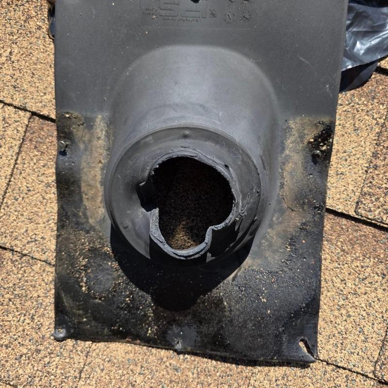 Damaged roof pipe boot on asphalt shingles Damaged roof pipe boot on asphalt shingles