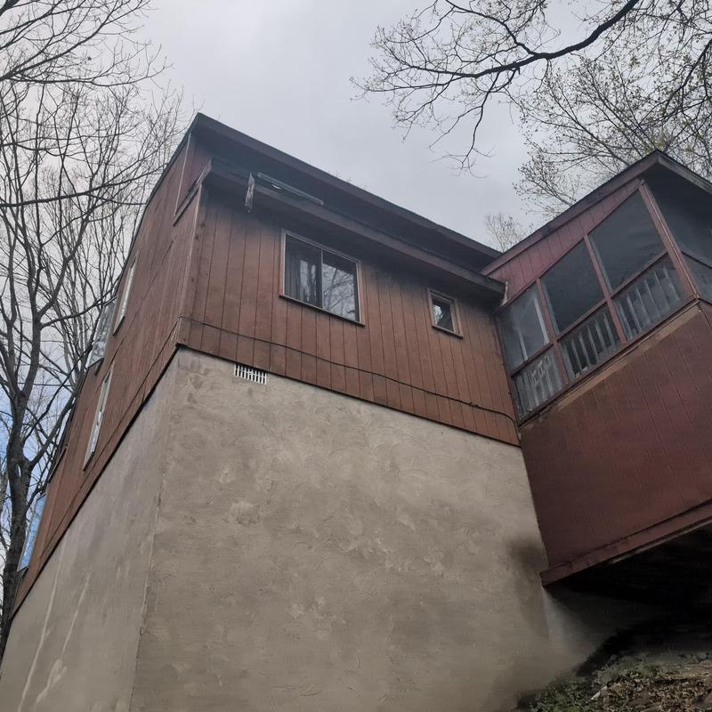Roof edge and gutter inspection on wooden house exterior Roof edge and gutter inspection on wooden house exterior