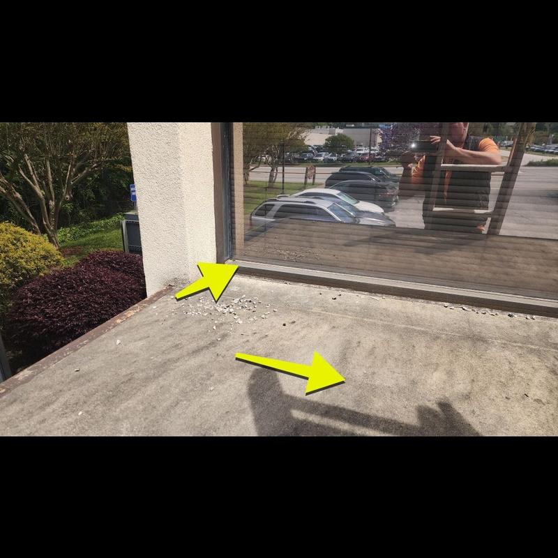 Concrete roof surface with damage near window edge Concrete roof surface with damage near window edge