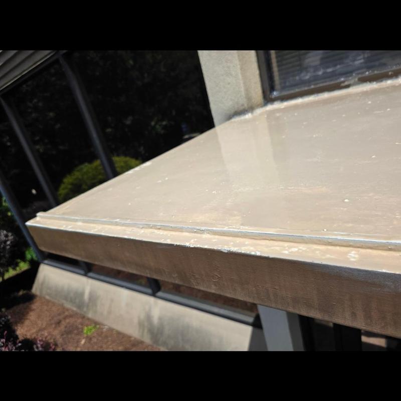 Concrete roof with tan silicone coating system installation Concrete roof with tan silicone coating system installation
