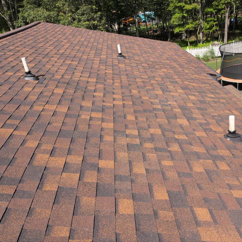 Asphalt shingle roof with vent pipes after replacement Asphalt shingle roof with vent pipes after replacement
