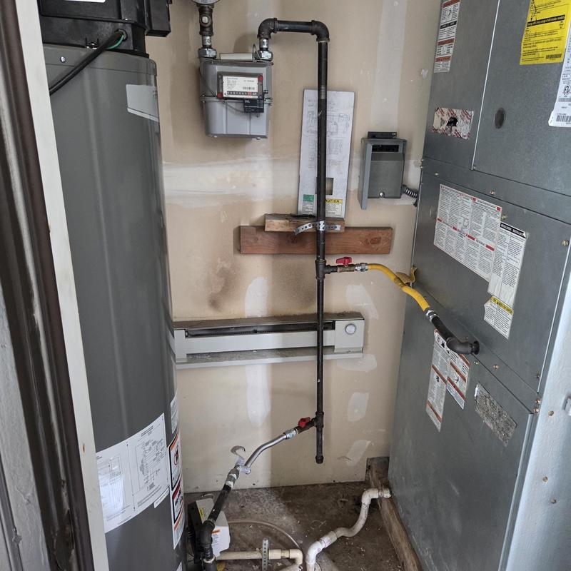Gas meter and piping near water heater and HVAC unit