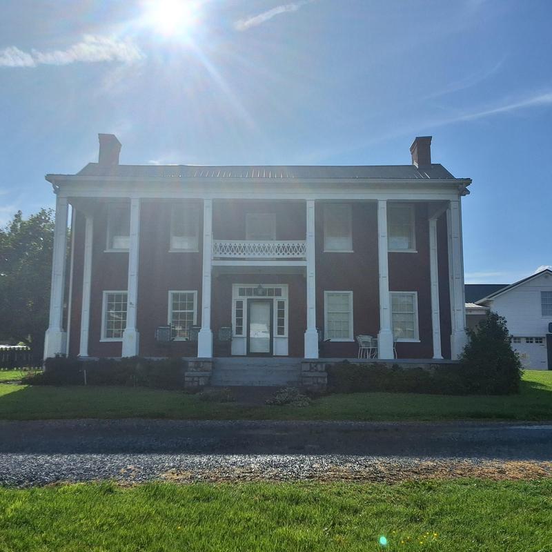 Metal roof on historic farmhouse under sun glare Metal roof on historic farmhouse under sun glare