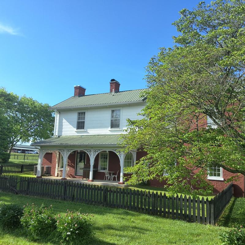 Metal roof on historic farmhouse with porch and chimney Metal roof on historic farmhouse with porch and chimney