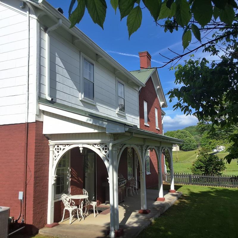 Gutter system on historic farmhouse porch exterior Gutter system on historic farmhouse porch exterior