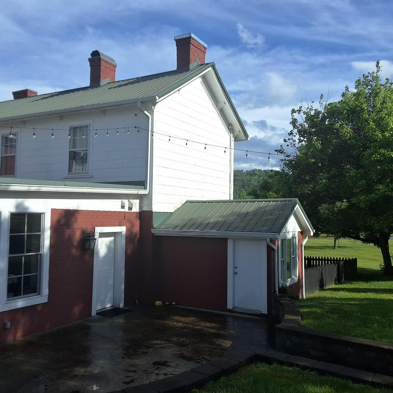 Metal roof on historic farmhouse exterior Metal roof on historic farmhouse exterior