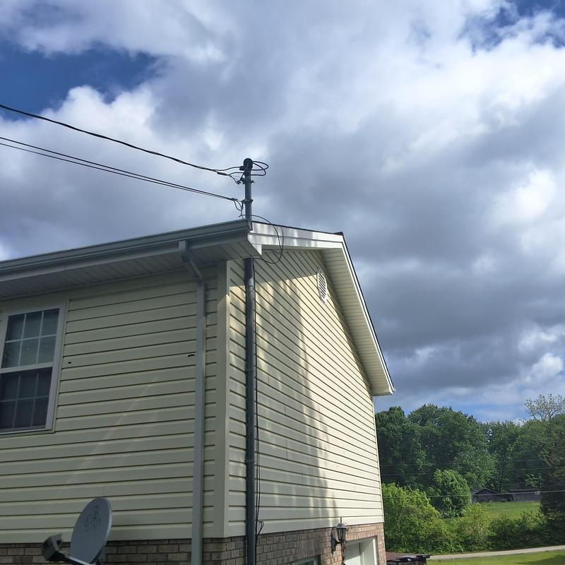 Satellite dish and power line at house exterior Satellite dish and power line at house exterior