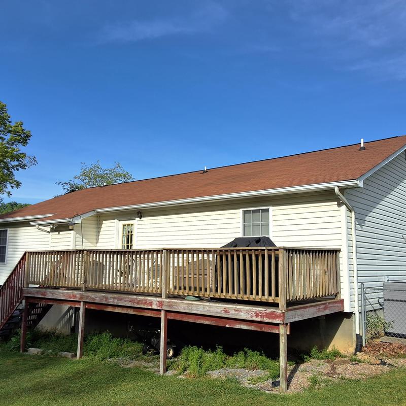 Asphalt shingle roof with wooden deck and railing Asphalt shingle roof with wooden deck and railing