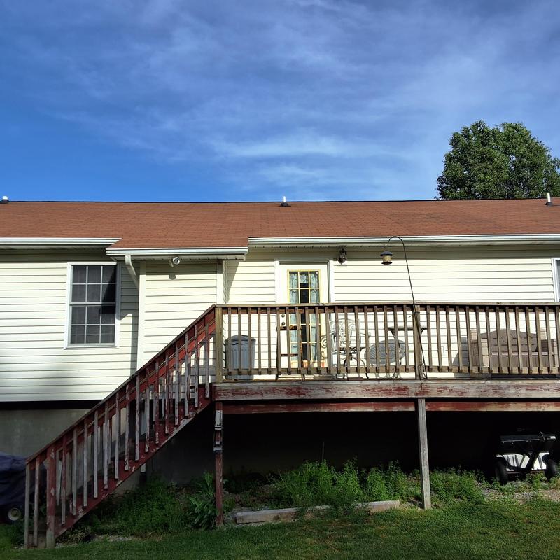 Asphalt shingle roof with wooden deck and stairs Asphalt shingle roof with wooden deck and stairs
