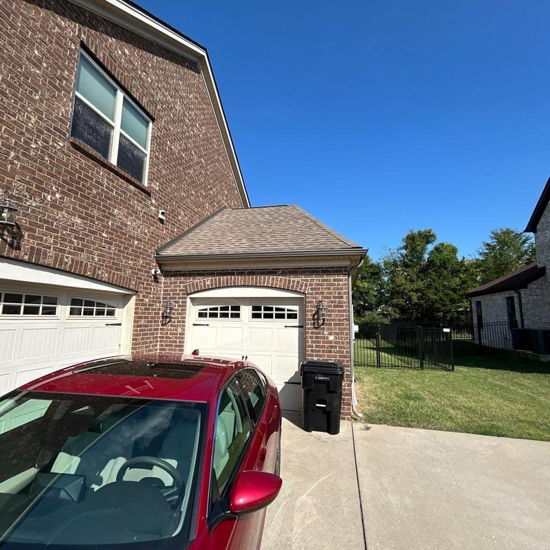 Roof shingles showing hail damage on residential garage roof