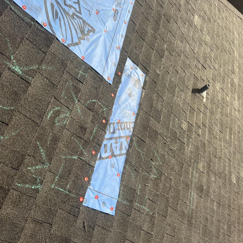 Asphalt shingle roof with exposed underlayment sections