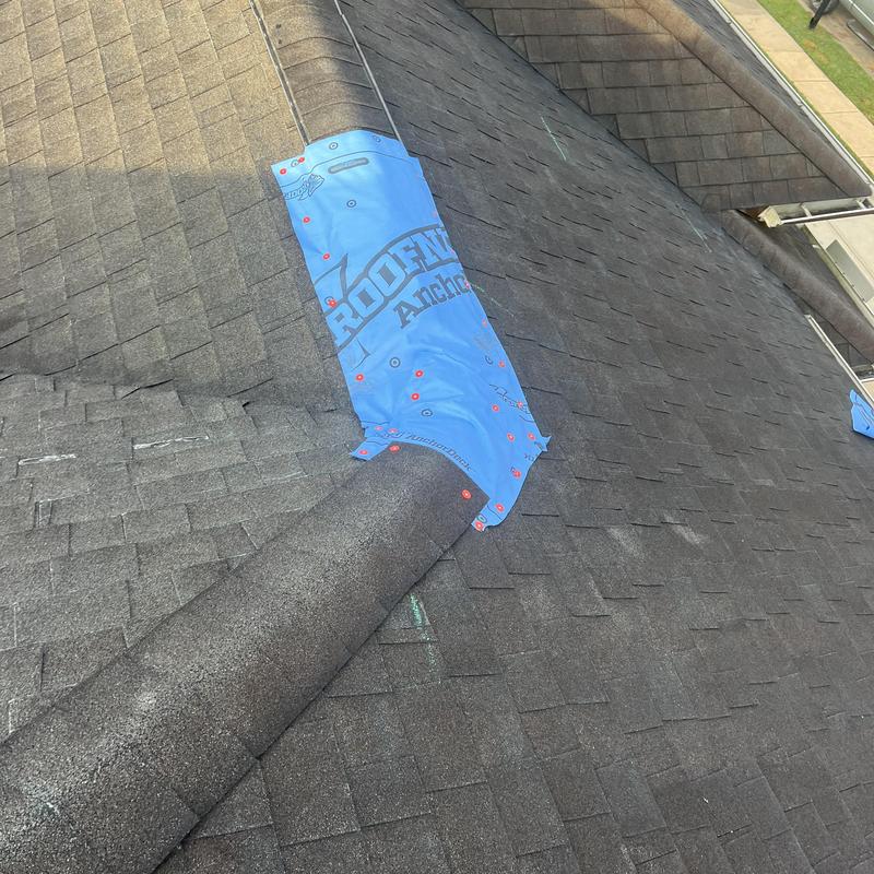 Roof ridge with protective underlayment on shingles