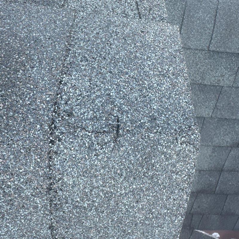 Asphalt shingles with visible hail damage close-up