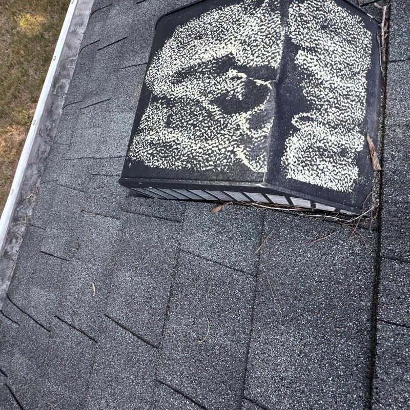 Roof vent with hail damage on asphalt shingles