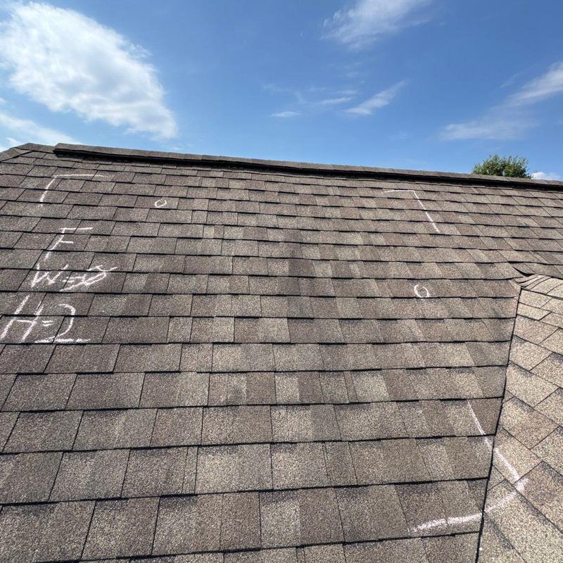 Asphalt shingle roof with marked hail damage inspection