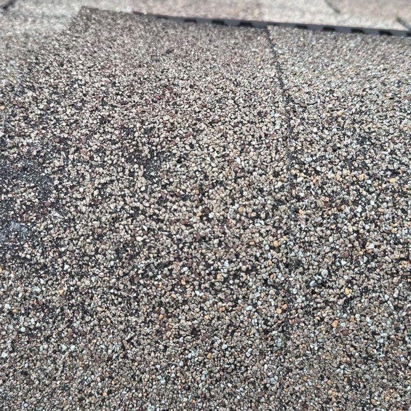 Asphalt shingle roofing granule surface with hail damage