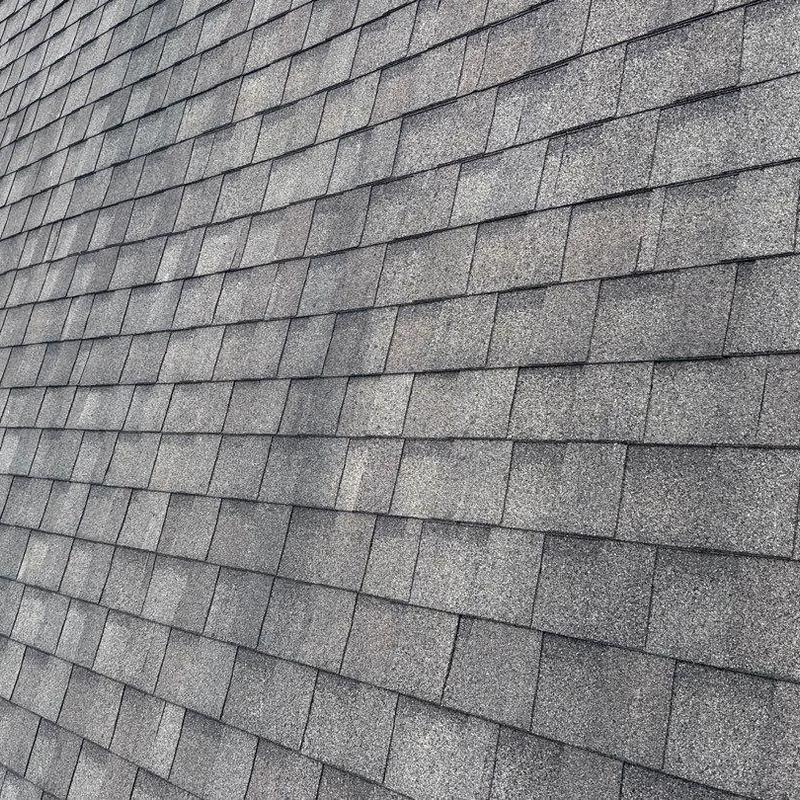 Asphalt shingle roof with visible hail damage spots