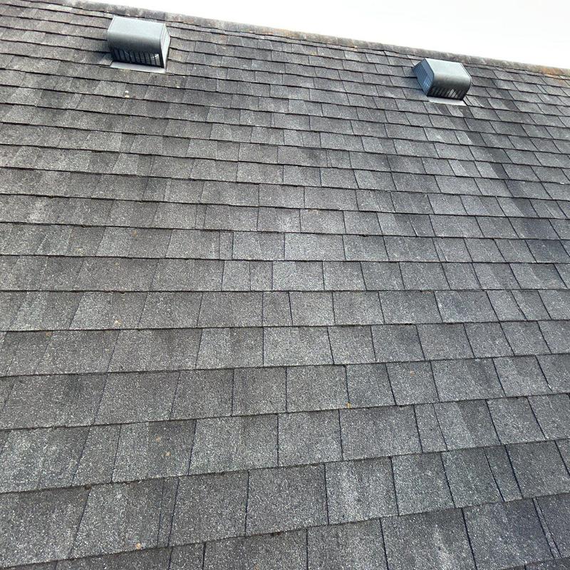 Asphalt shingle roof with hail damage and ventilation vents