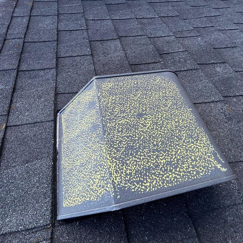 Roof shingles hail damage near metal vent cover