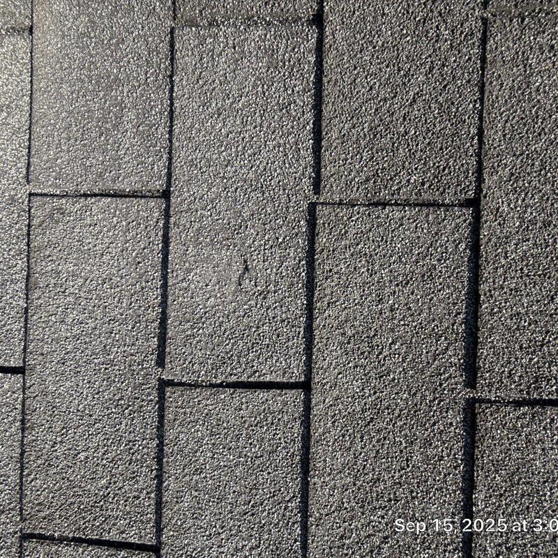 Asphalt shingles with hail damage on roof surface