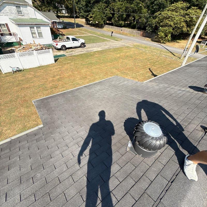 Roof shingles with turbine vent and inspection shadows