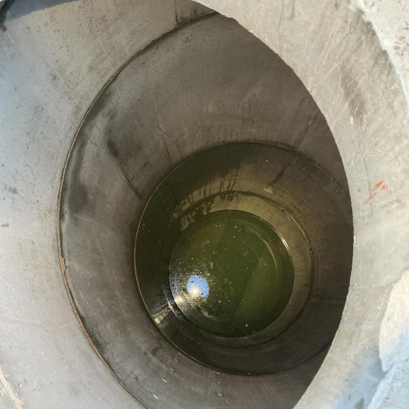 Concrete sewer manhole with standing water inside